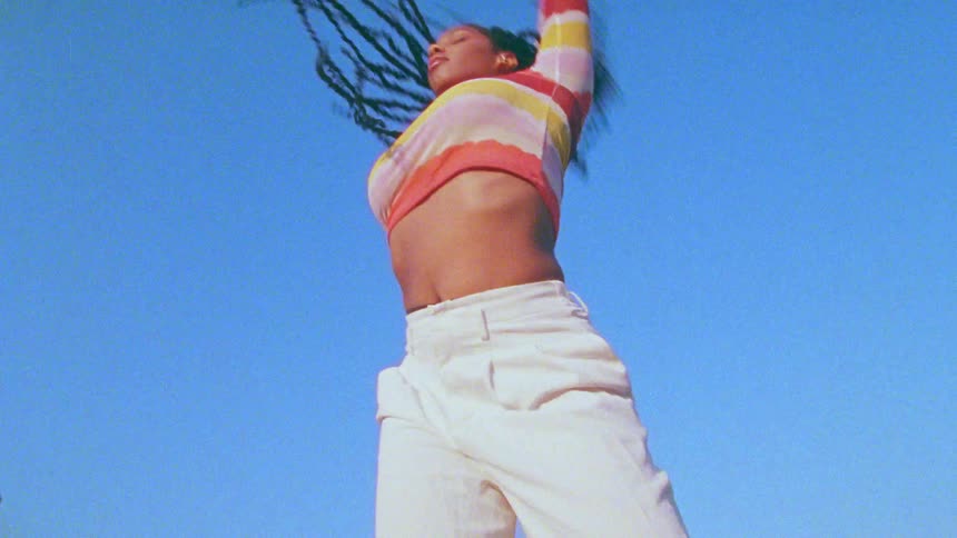 A teenage girl dances outside