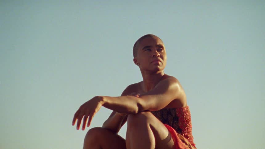 A portrait of a woman sitting around outside