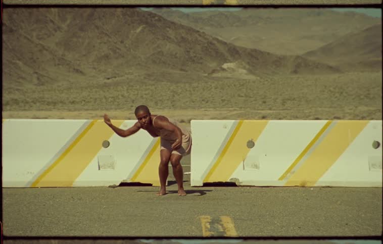 A woman dancing outdoors on a sunny day