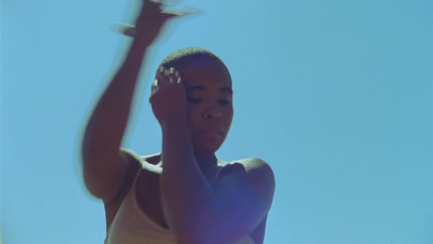 A woman dances in the sunshine