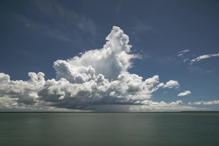 Timelapse of white clouds forming and passing over the surface of a lake