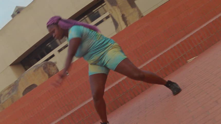 Black woman dancing outdoors