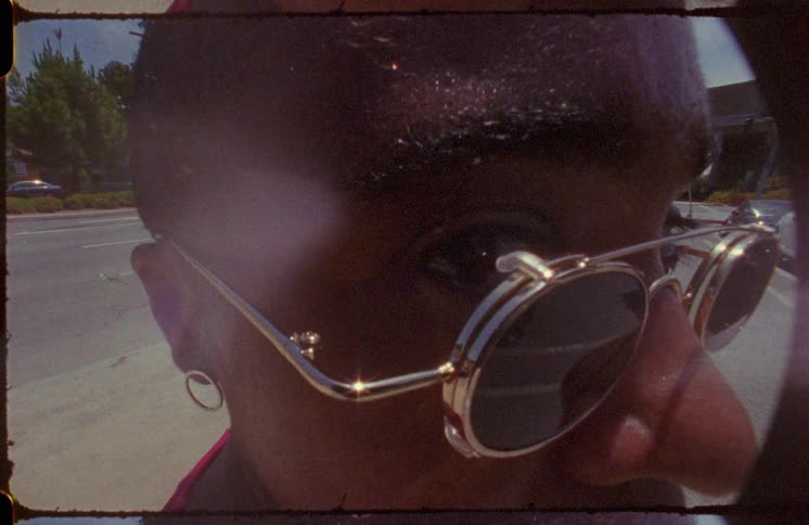 Close up of the sweat on the forehead of a bald woman standing on the street