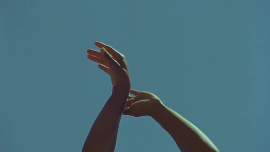 A woman dancing with her hands in the air
