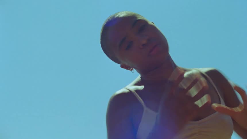 A woman is dancing on a sunny day