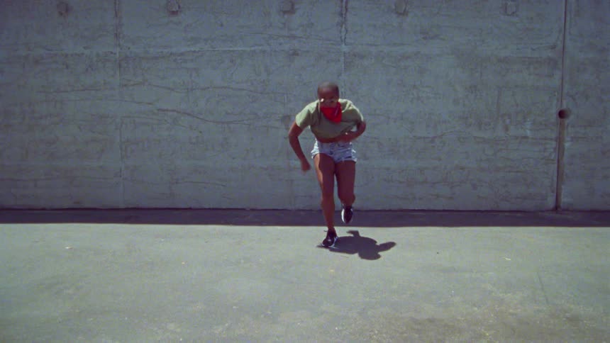 A woman is dancing outside in the lot