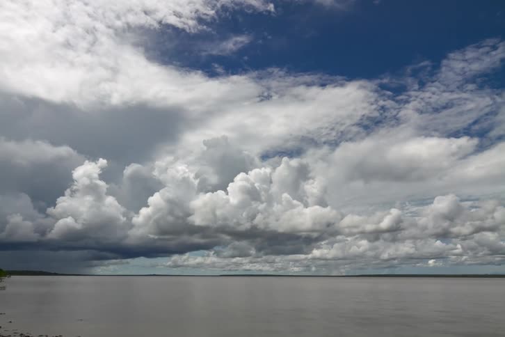 Cumulus clouds move across the sky on a very cloudy day