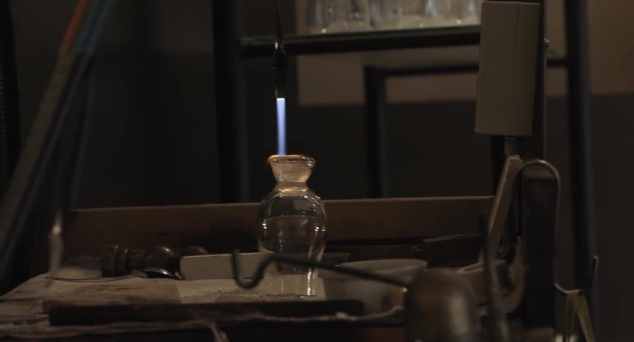 A torch heats the bottom of a glass