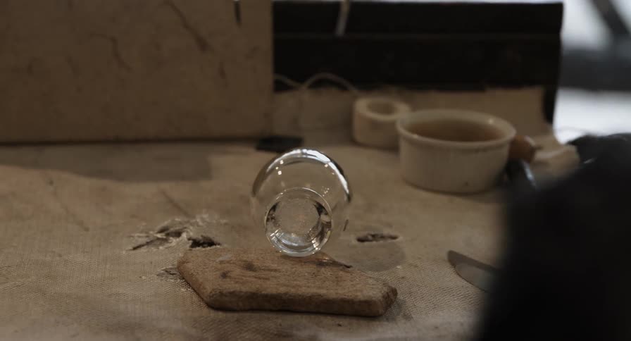 A person uses a torch to finish a handmade glass