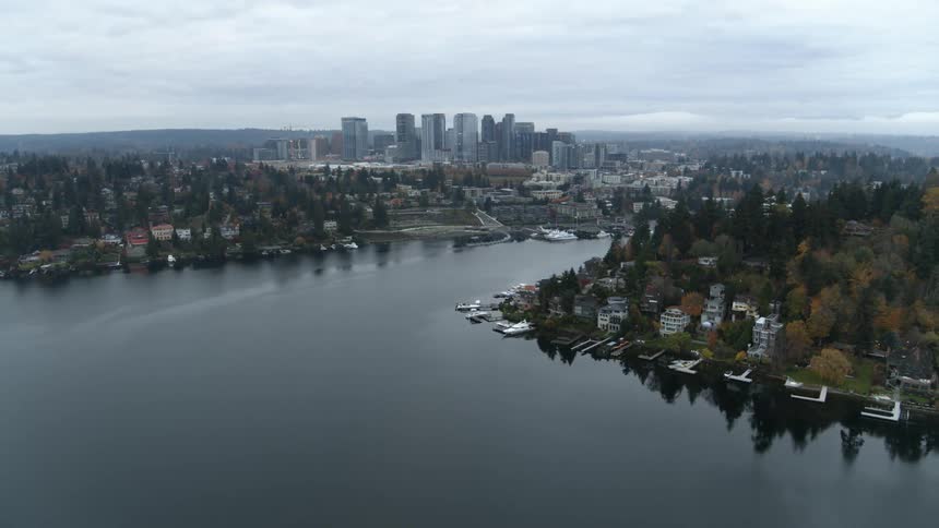 The skyline of downtown Bellevue in the distance behind trees and homes of a hillside neighborhood