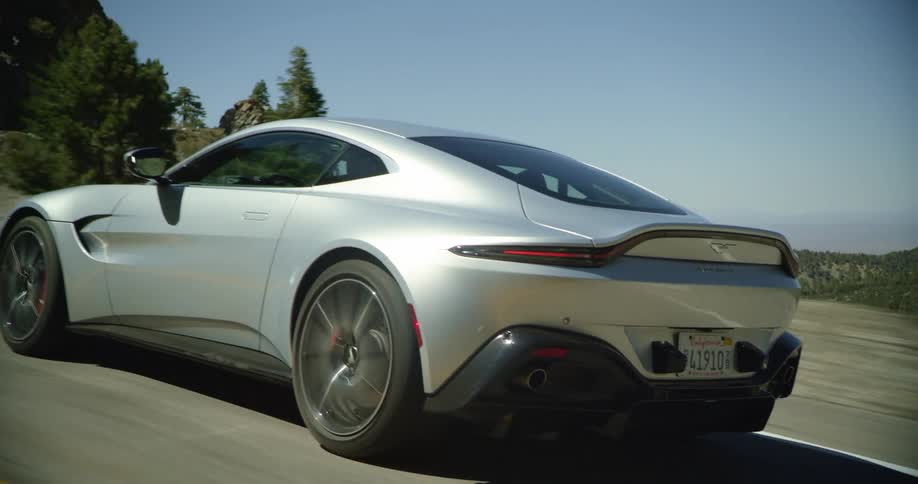 A vehicle is racing on the highway near the cliff