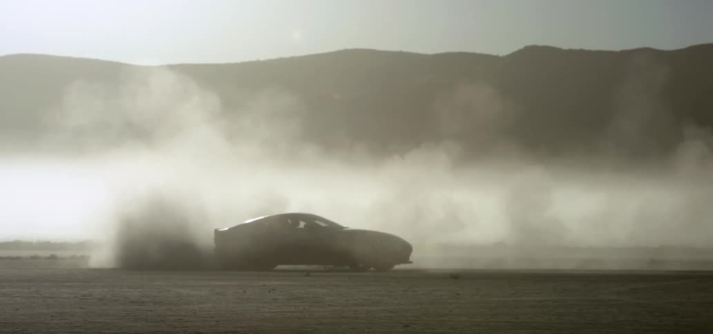 A car spins in circles and cause dust to billow all over