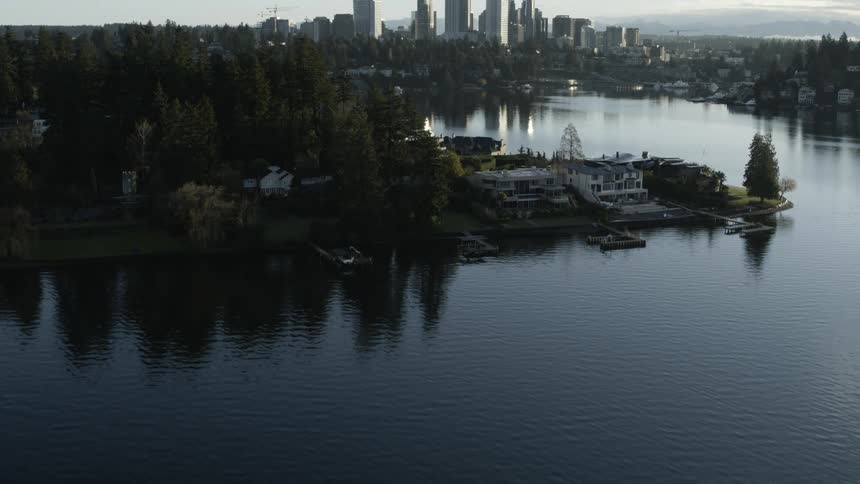 Tilt up from Lake Washington to reveal the Bellevue skyline behind Meydenbauer Bay