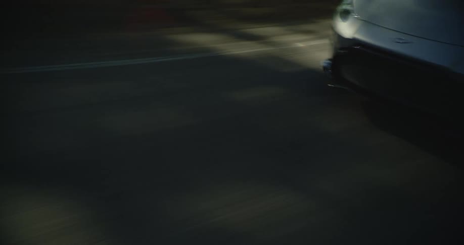 Coup sports car driving fast on a road in the mountains