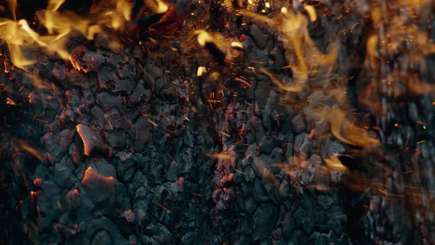 The wood is burning and flaking apart
