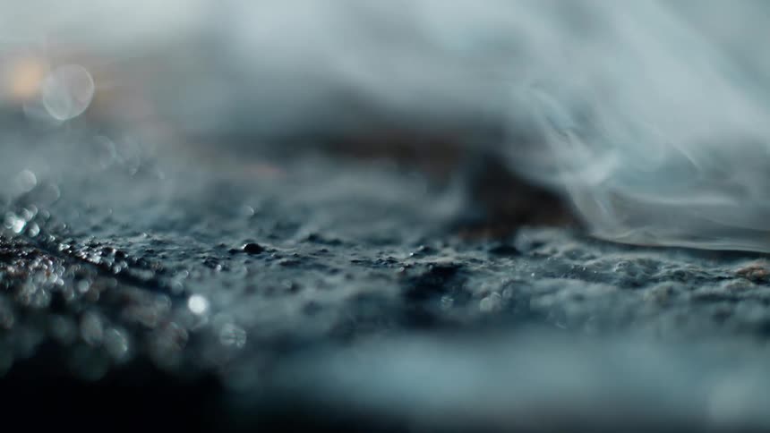 Gray black and orange colors that look like the ground wet with fire and smoke