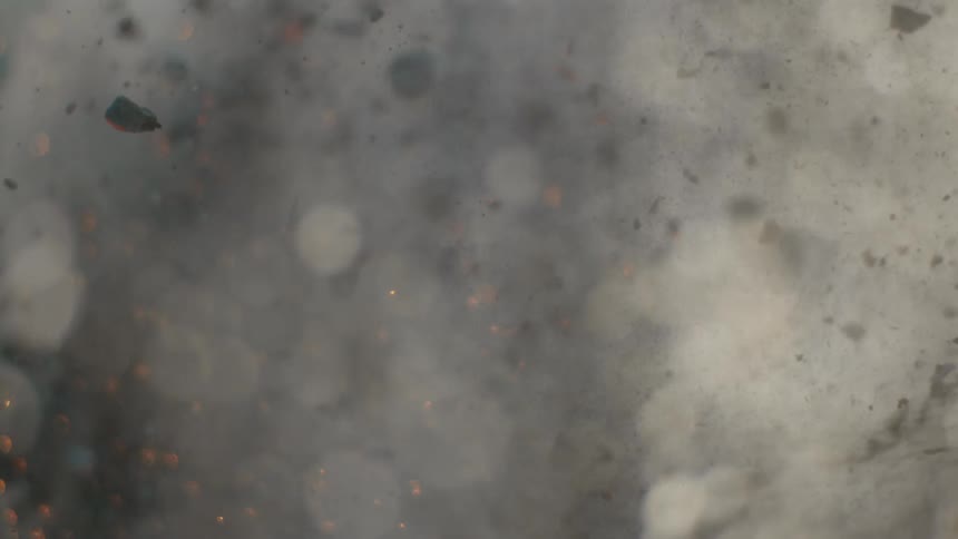Ashes and embers floating in thick smoke
