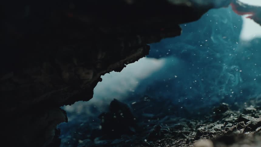 Smoke and ashes rising from the burned soil
