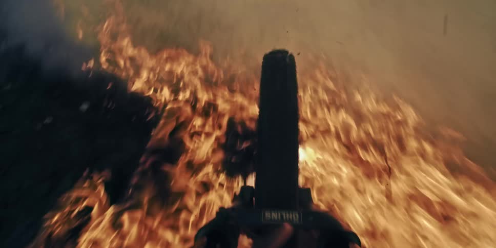 Point of view of a bike jumping over flames and smoke