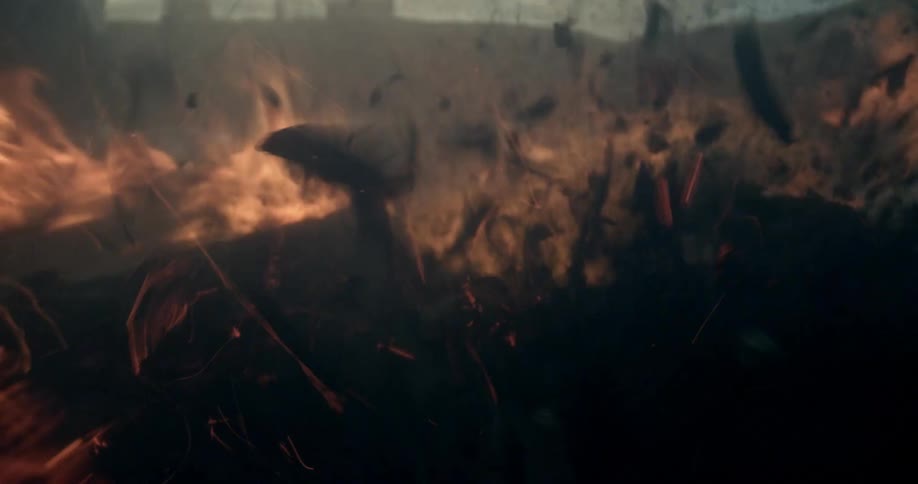 Smoke ashes and embers explode from the flames of burning wood