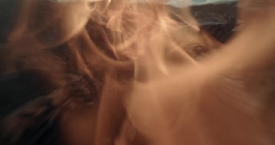 Camera traveling down flaming inside of log.