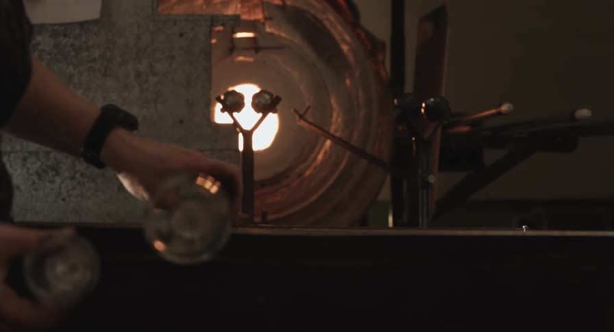 A glass is being spun by a woman