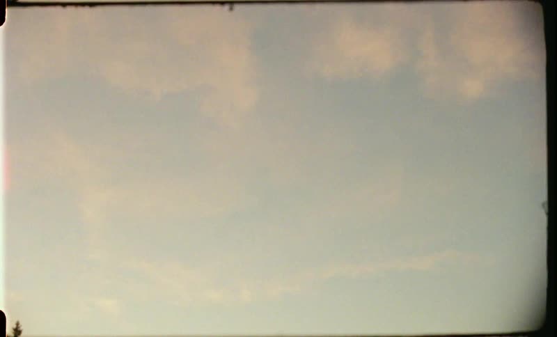 White thin clouds in the blue sky at sunset caught on film