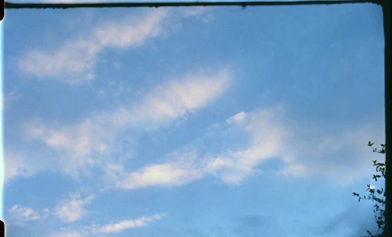 White thin clouds in the blue sky at sunset caught on film
