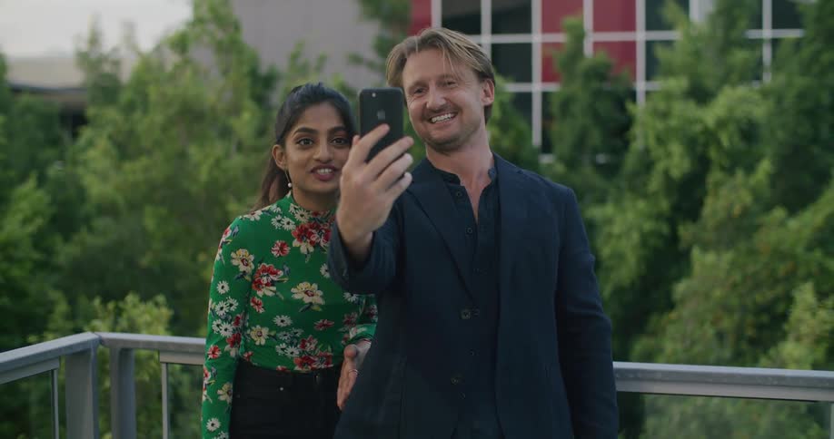 Female and male talking to phone