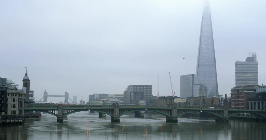 Vehicles travel a low bridge across the river to and from large cities