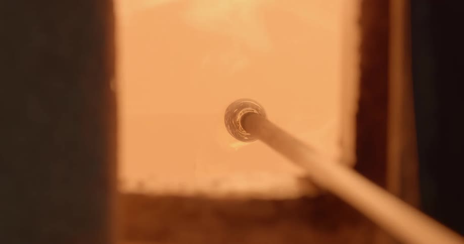 Glass is being blown in a kiln