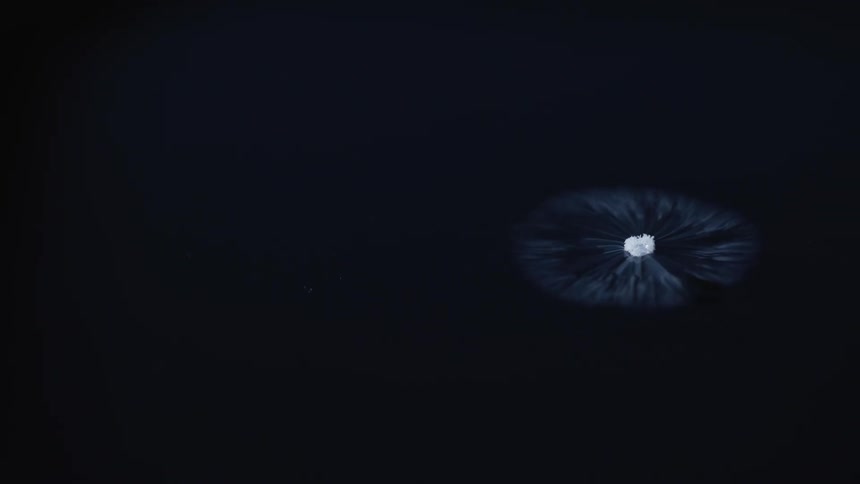 Bright white center moves across blackness surrounded by expanding flowing circle of tendrils