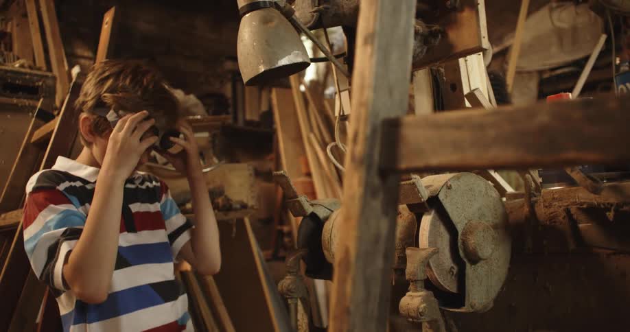 A child is playing around with goggles in the workshop