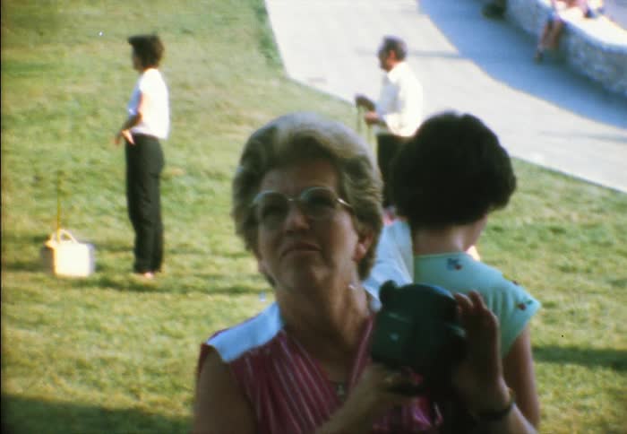 Woman on vacation uses a vintage camera to film