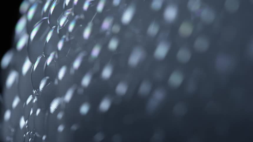 Wall of bubbles filled with white smoke on a dark room