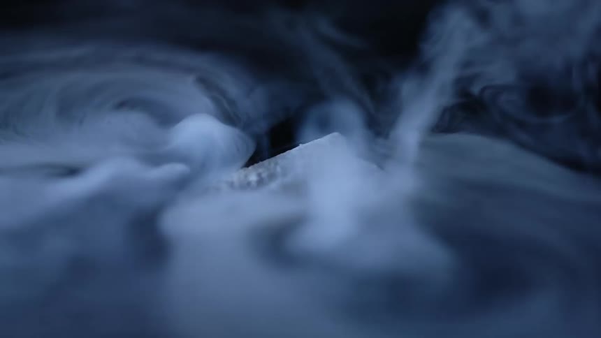 A single piece of dry ice evaporates quickly as it floats atop some water