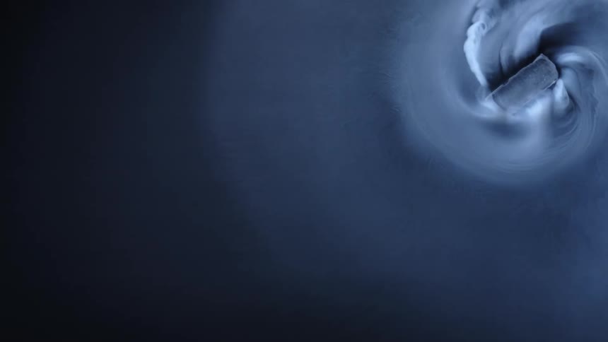 A digital design mimics a concrete brick spinning in liquid and then shooting off