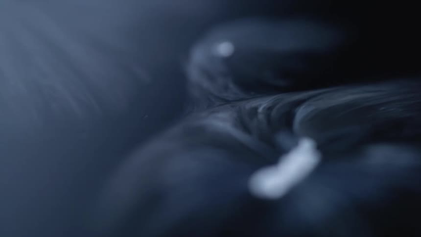 White smoke floating and swirling around dry ice floating in water
