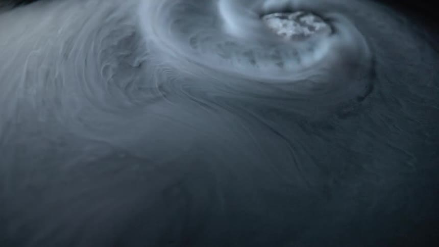 Black white and gray colors that look like a piece of liquid nitrogen spiraling across the table