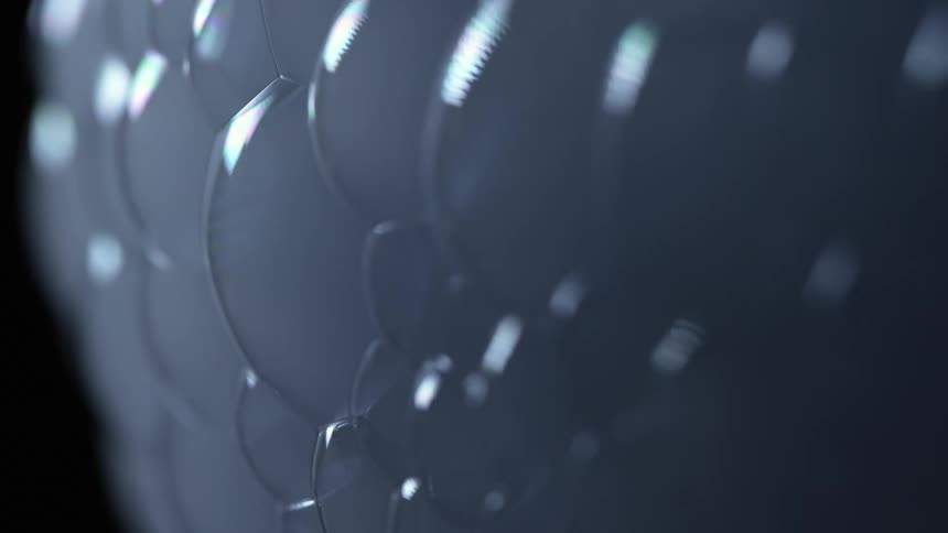 Wall of bubbles filled with white smoke on a dark room