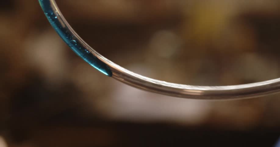 Thick transparent blue liquid moving inside a plastic tube