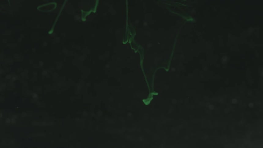 Green smoke floats in a dark area