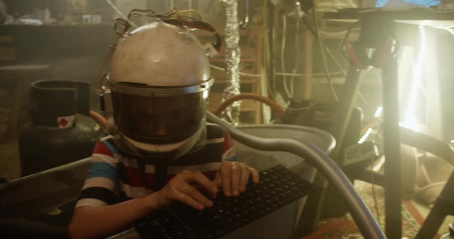 A child is wearing a helmet and playing in the tub