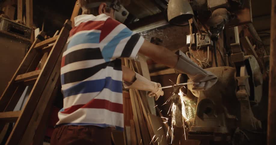 A person working on metal on a grinder