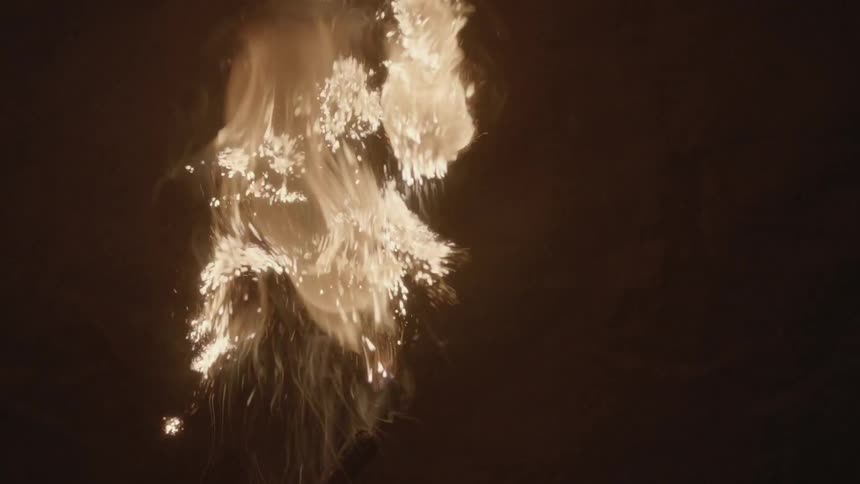 A fireball bursts in a dark area