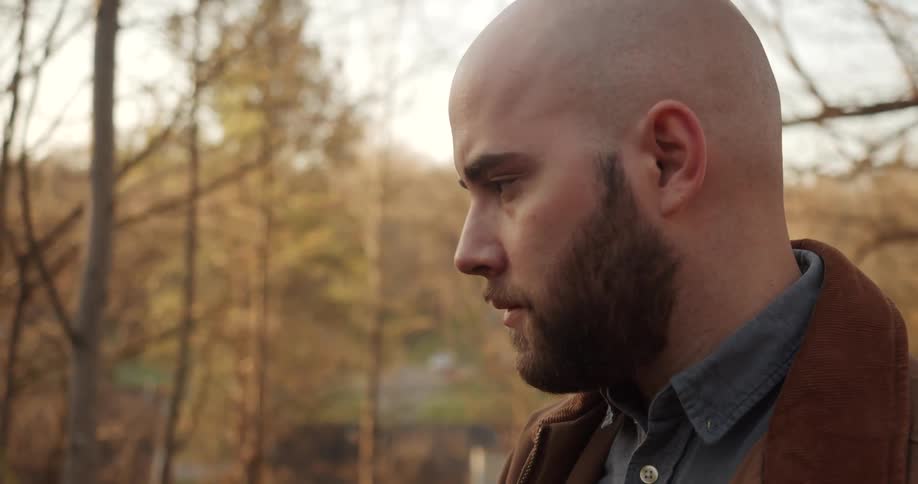 A view of a man looking into the distance and thinking