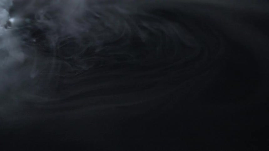 White smoke floating and swirling around dry ice floating in water