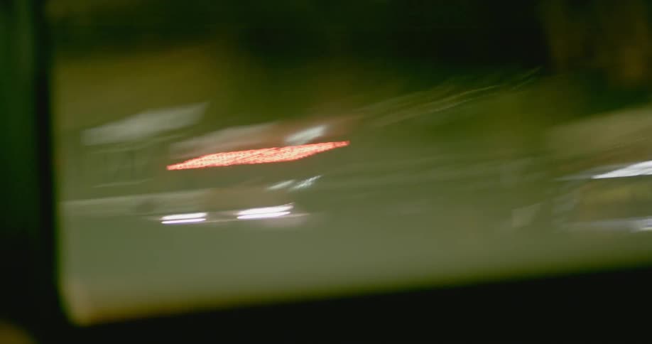 City lights as seen from a passing vehicle