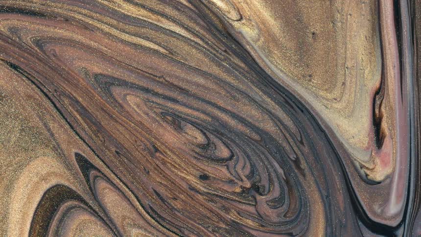 Small particles glitter and shimmer among textured paint swirls