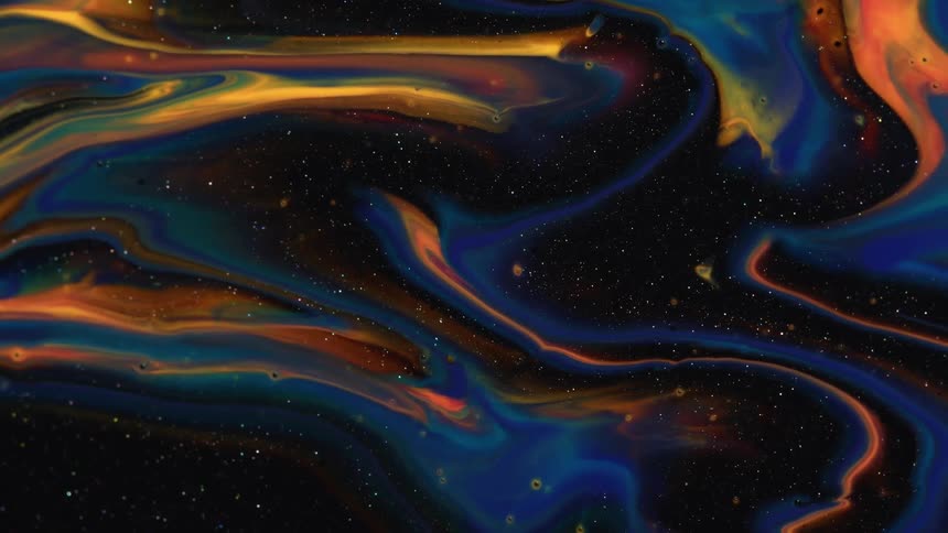 Swirls of colorful sparkling liquid ink forms psychedelic abstract paterns